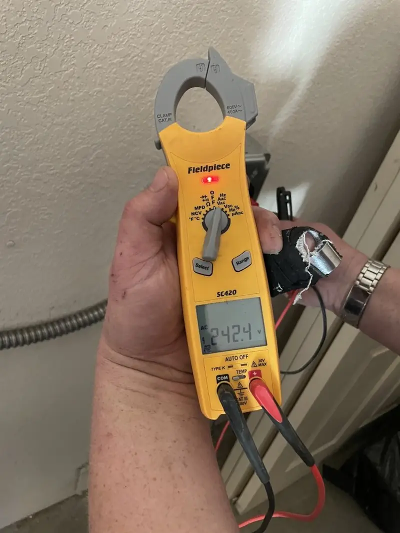 Voltage testing with clamp meter during Recessed Lighting Installation in Payson